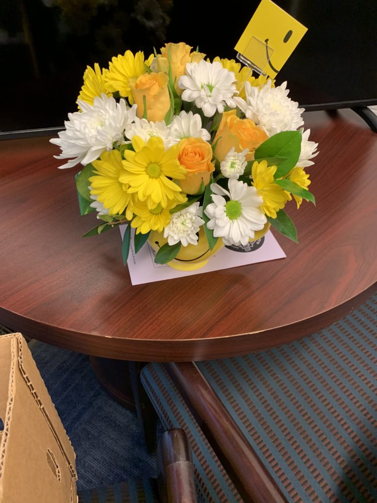 A yellow and white bouquet of flowers.