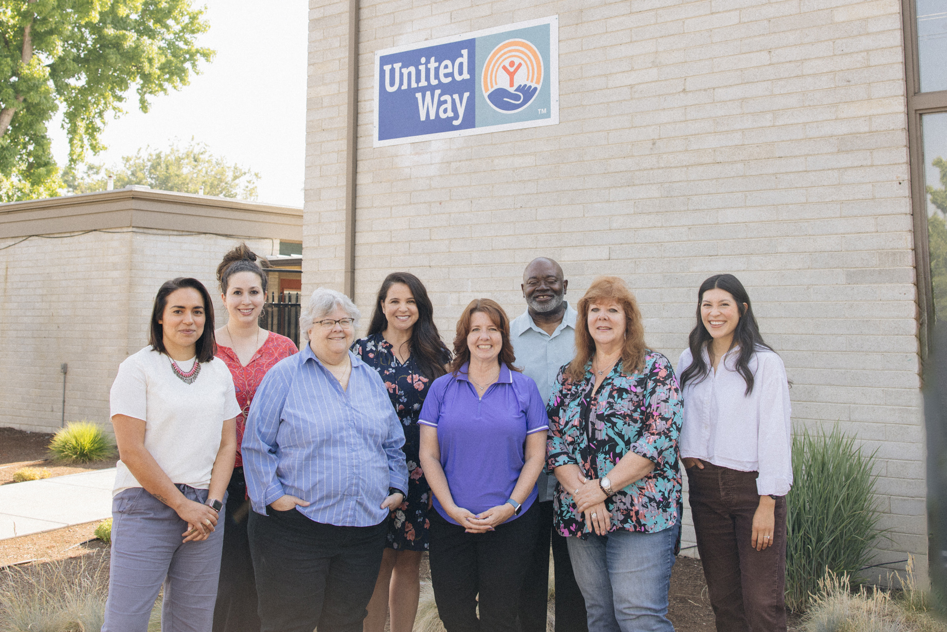 Staff group photo in front of United Way sign.