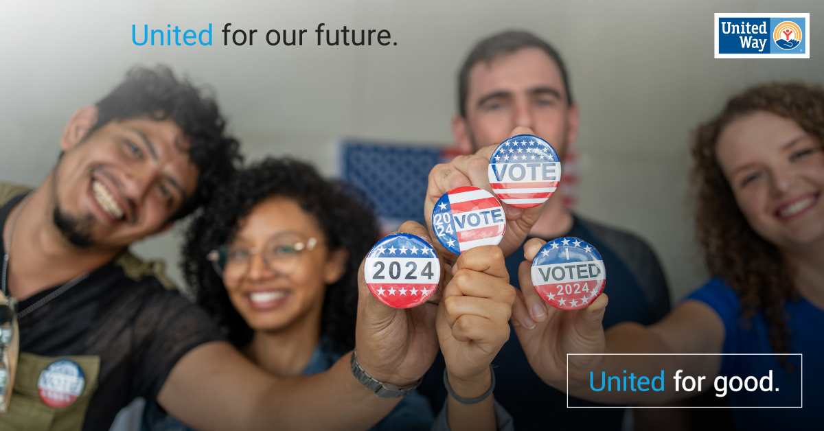 A group of men and women holding up red, white and blue vote 2024 buttons.