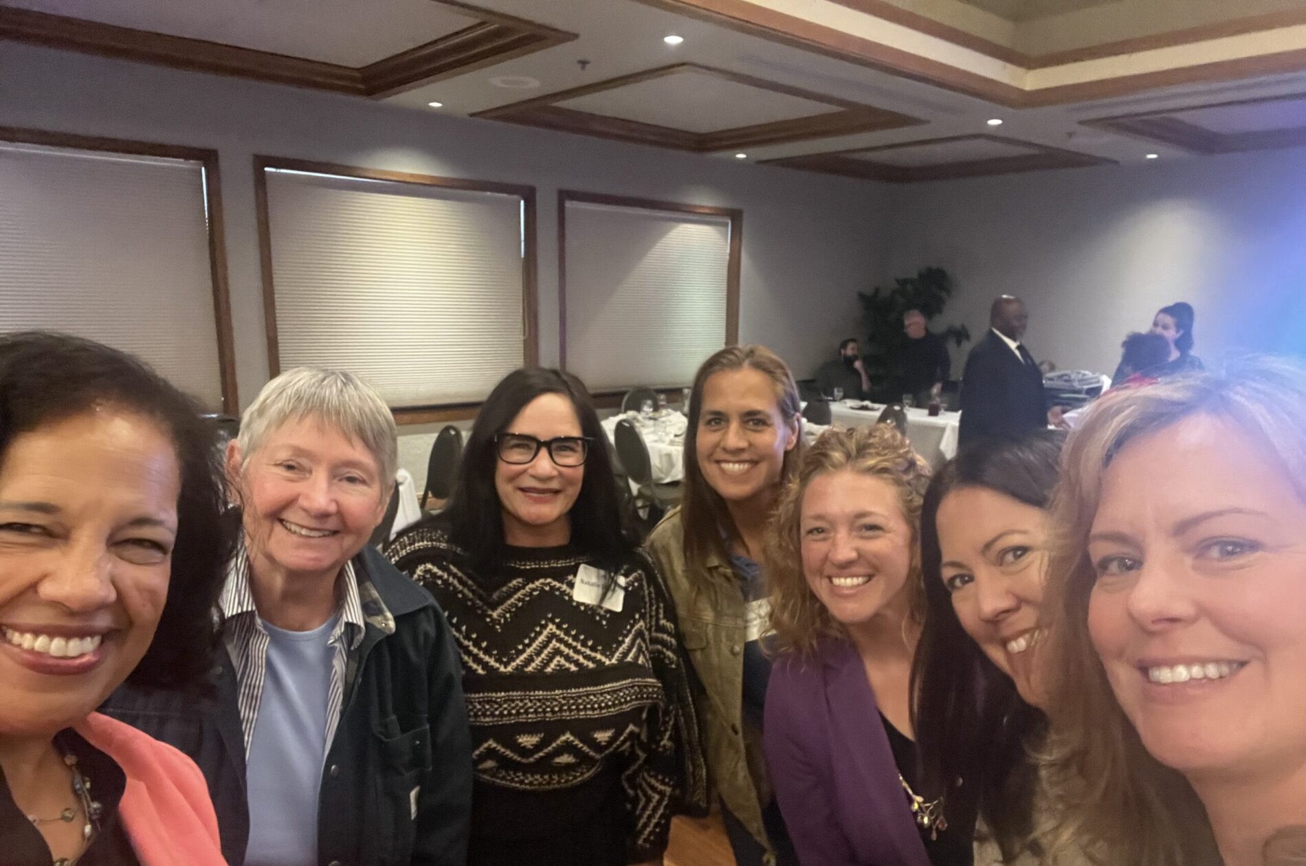 Lisa Mensah joins a group of women to give key note speech at WiLL luncheon.