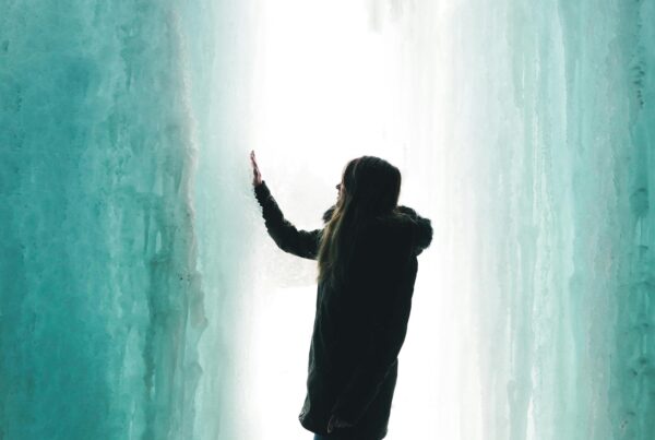 Girl standing in a glacier.