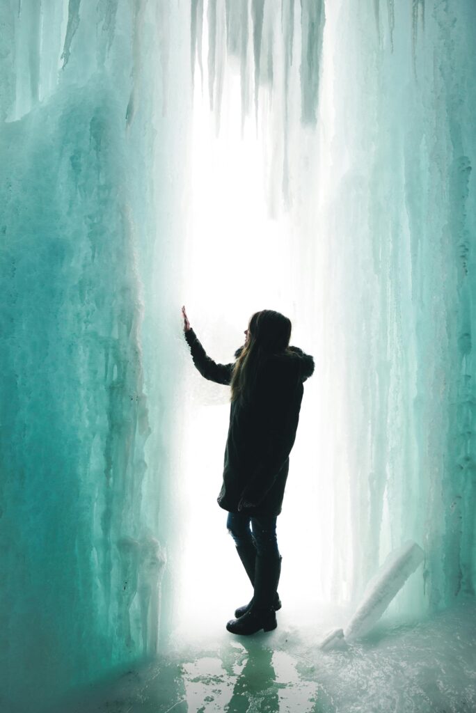 Girl standing in a glacier.