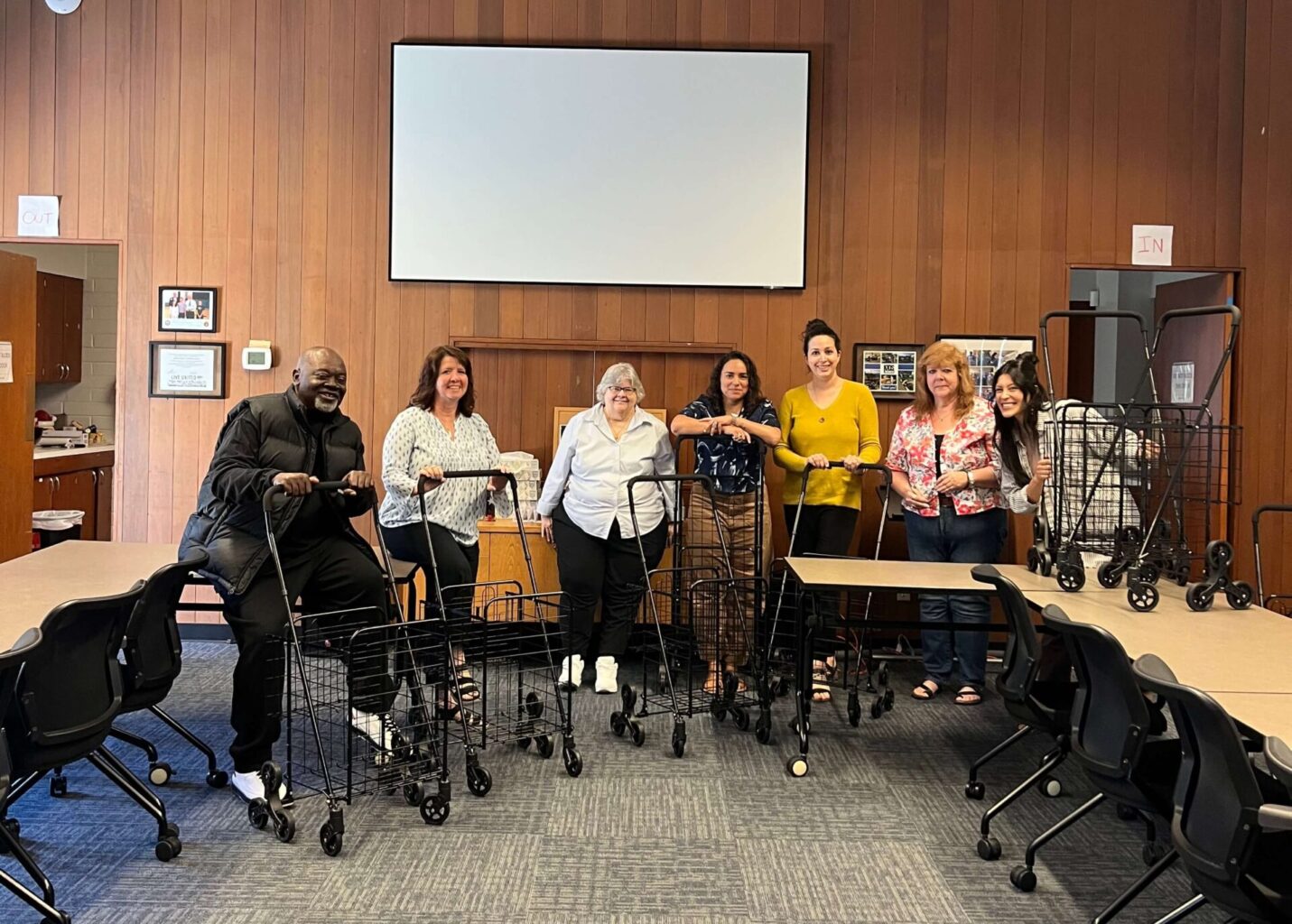 United Way of Jackson County Staff posing for a photo with roller carts sponsored by Jackson Care Connect.